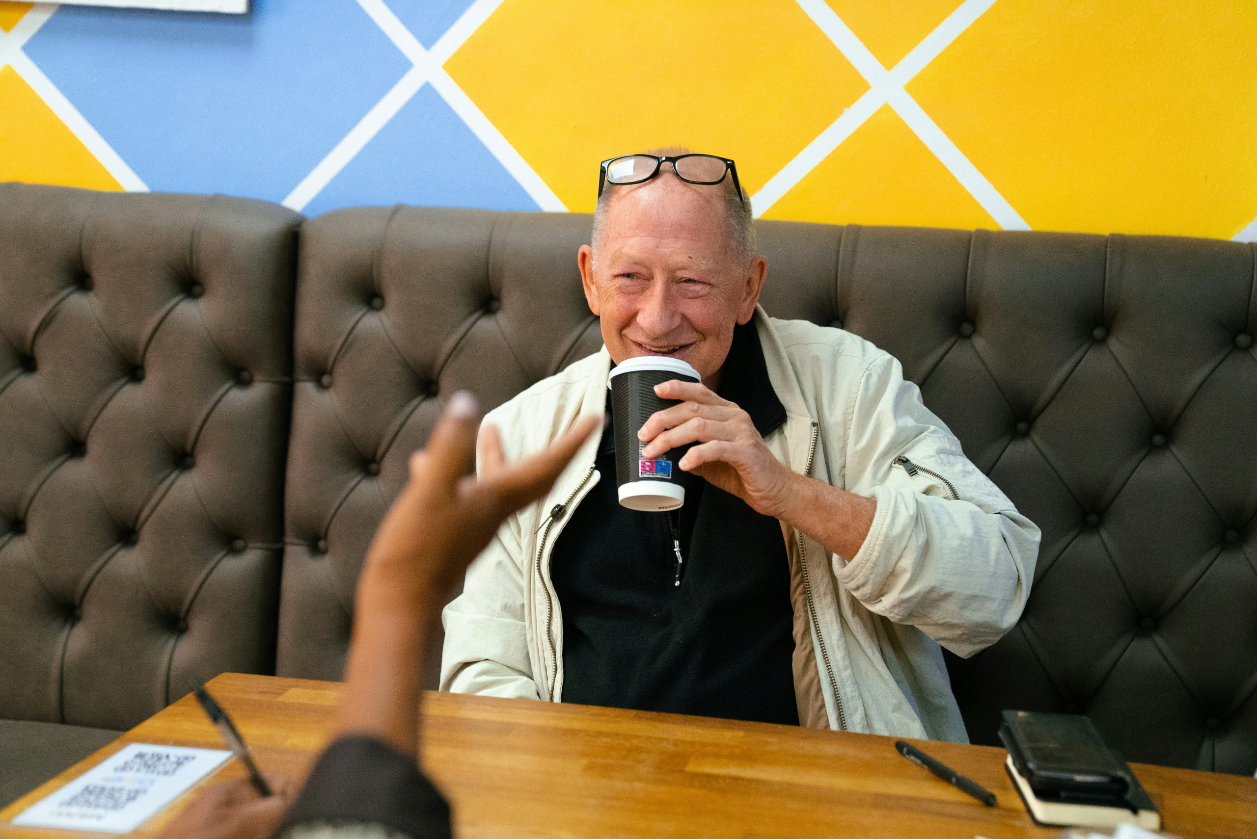 AB senior man drinking coffee with friend