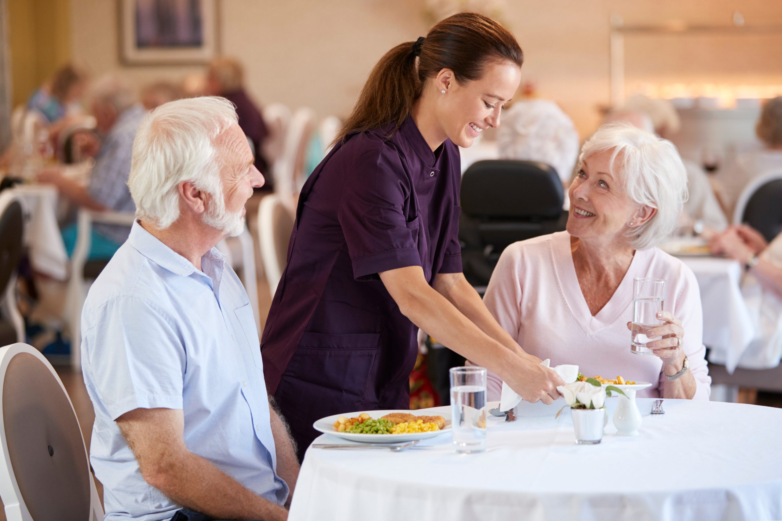two seniors eating a meal